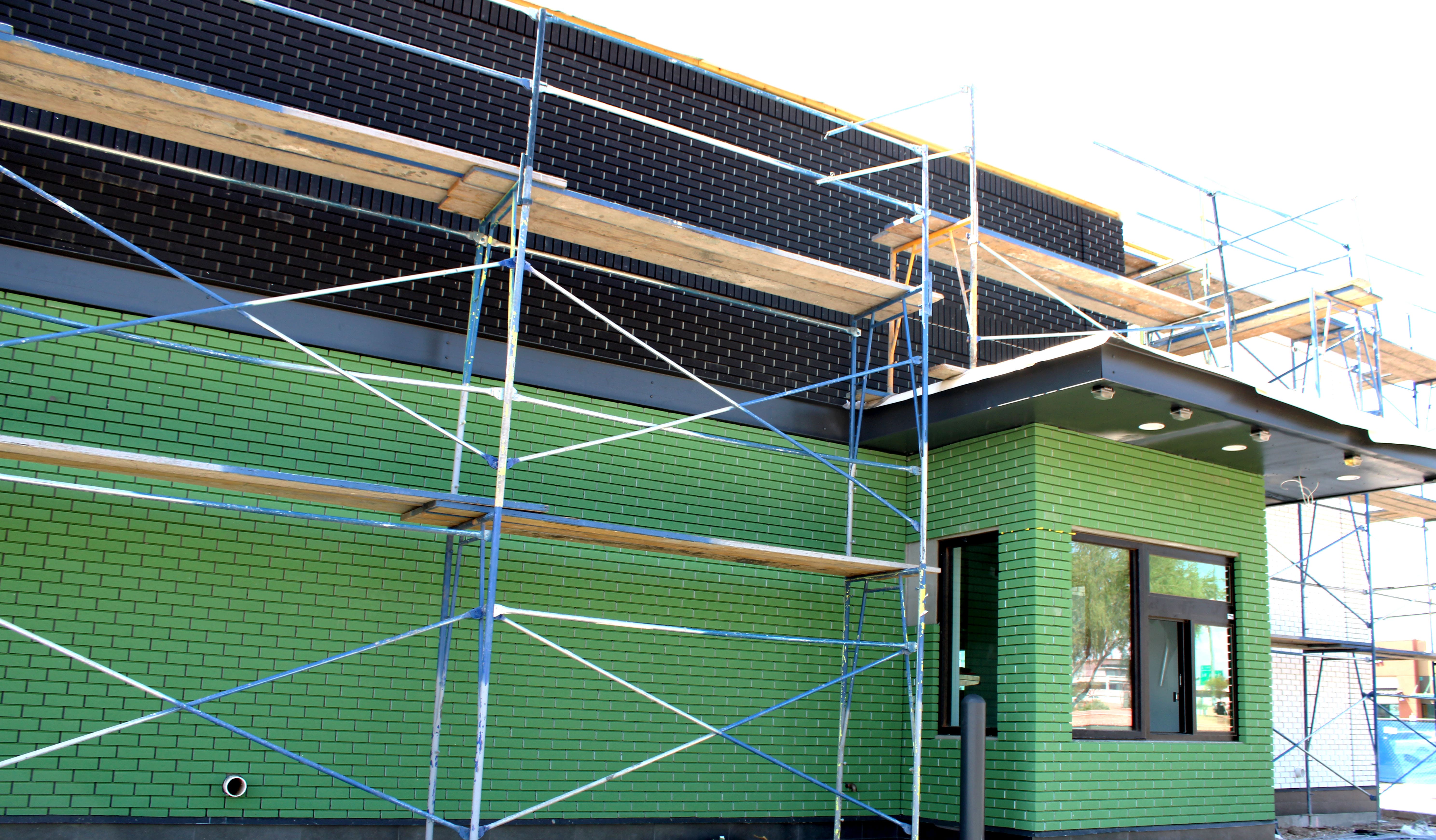 Stucco garage with two brown doors